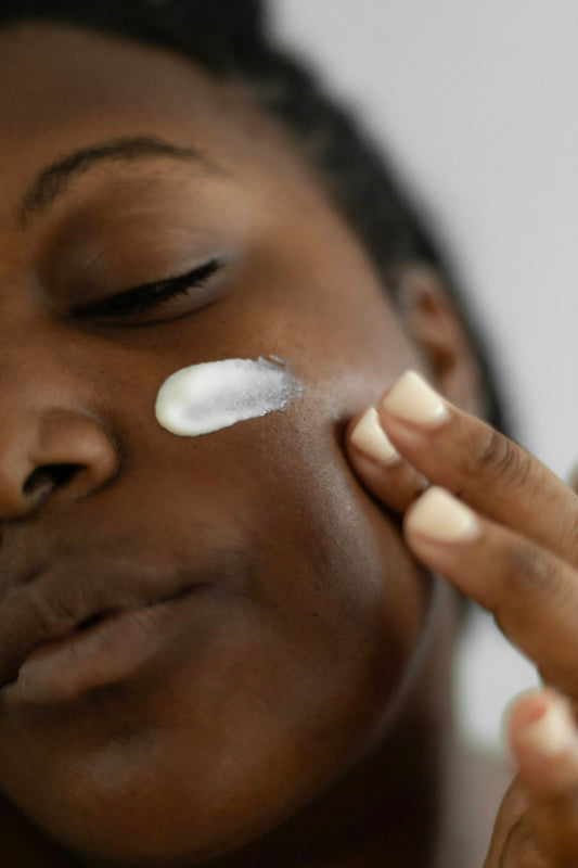Woman applying moisturizer to her face
